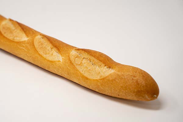 Freshly baked French baguette with a golden scored crust